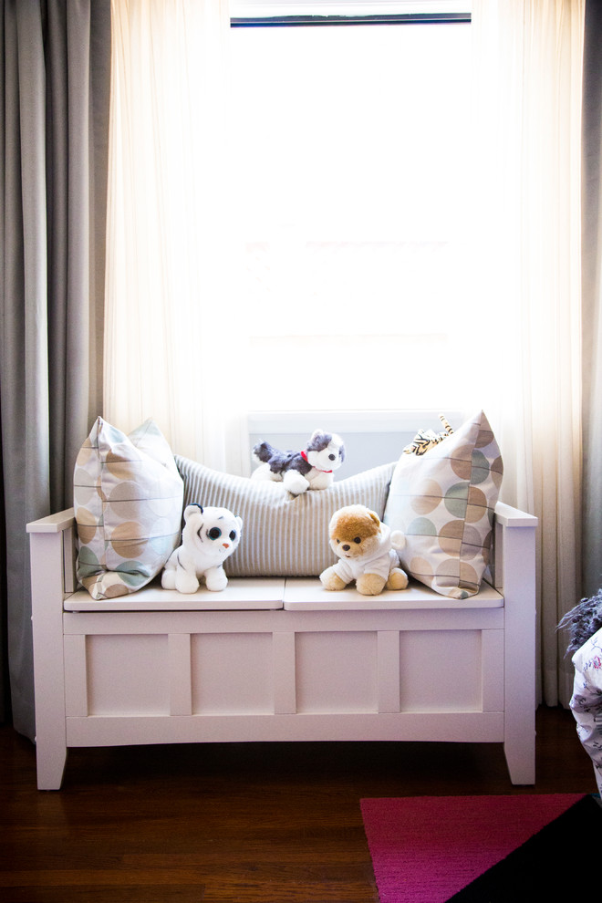 This is an example of a medium sized classic children’s room for girls in Los Angeles with grey walls, dark hardwood flooring and brown floors.