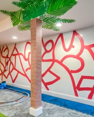 Minimalist gender-neutral kids' room photo in San Diego with red walls
