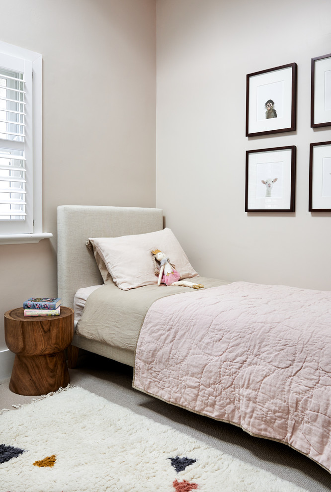 This is an example of a contemporary kids' bedroom in Sydney with pink walls, carpet and blue floors.