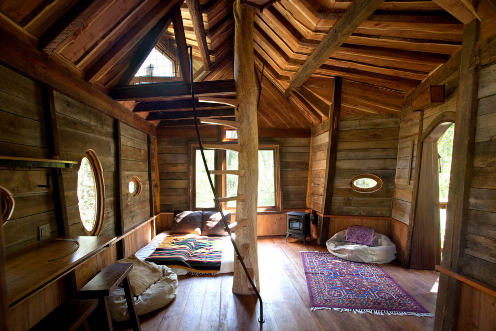 Example of a mountain style gender-neutral medium tone wood floor kids' bedroom design in Denver