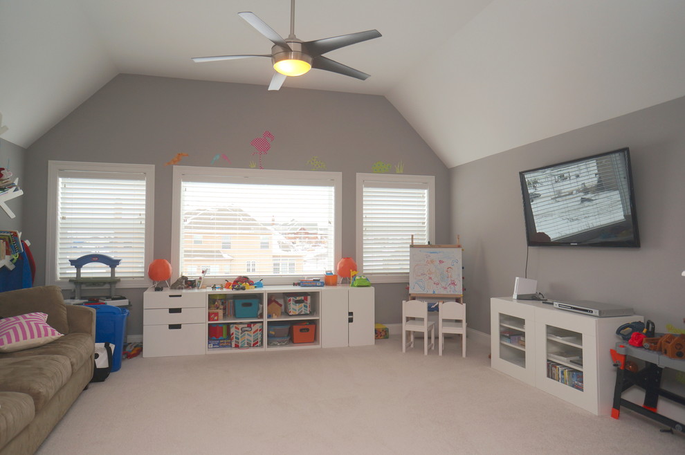 This is an example of a medium sized traditional gender neutral kids' bedroom in Chicago with grey walls and carpet.