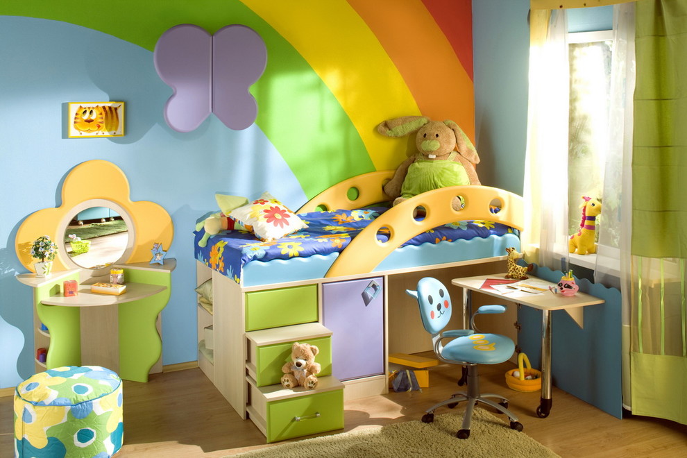 Example of a small minimalist gender-neutral light wood floor kids' room design in Miami with multicolored walls