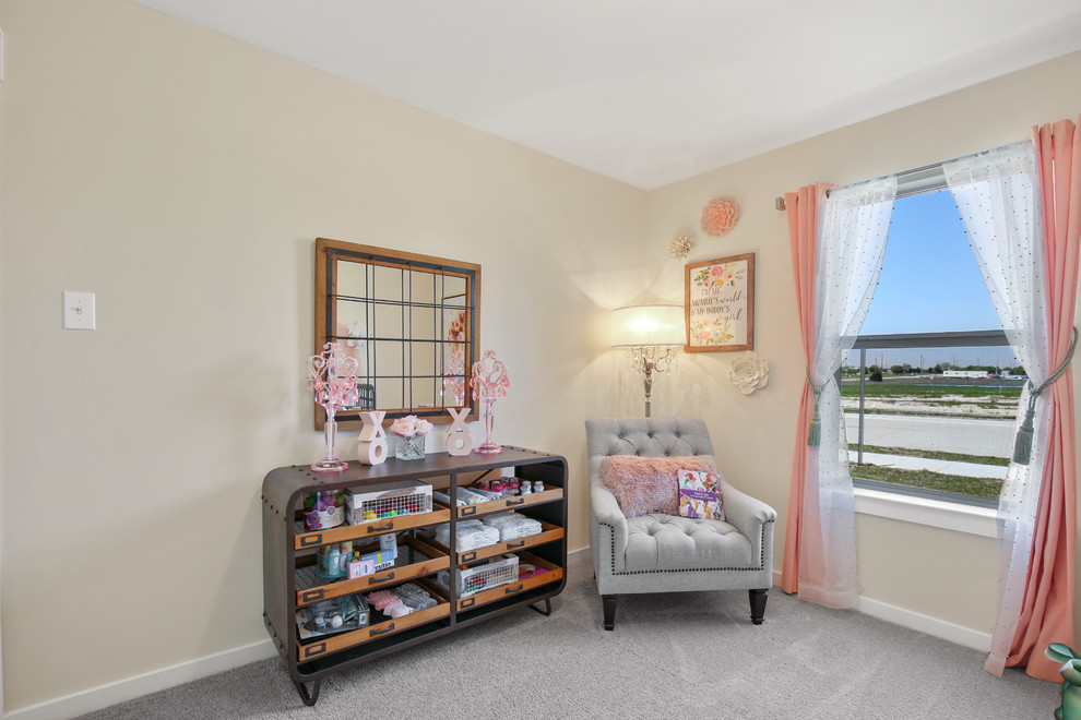 Photo of a large classic toddler’s room for girls in Dallas with beige walls, carpet and beige floors.
