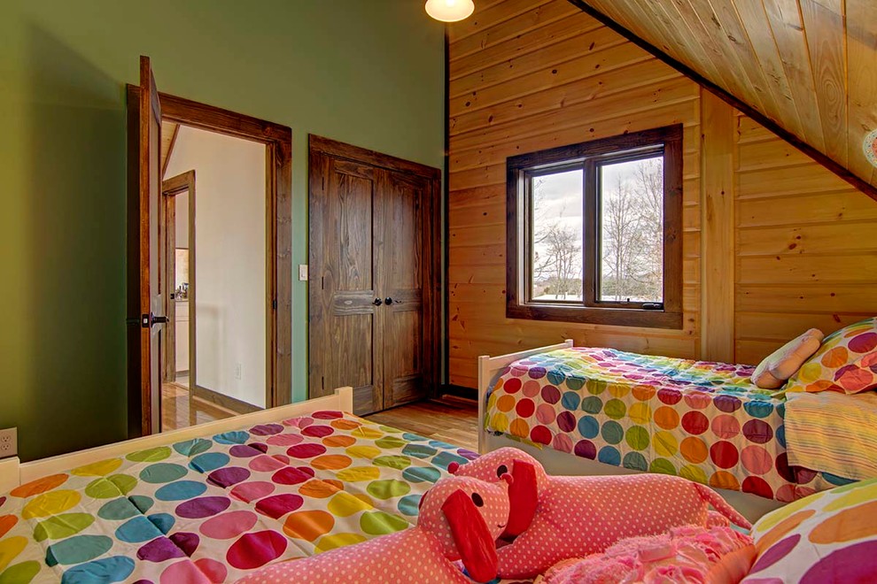 This is an example of a large rustic kids' bedroom in Charlotte with medium hardwood flooring.