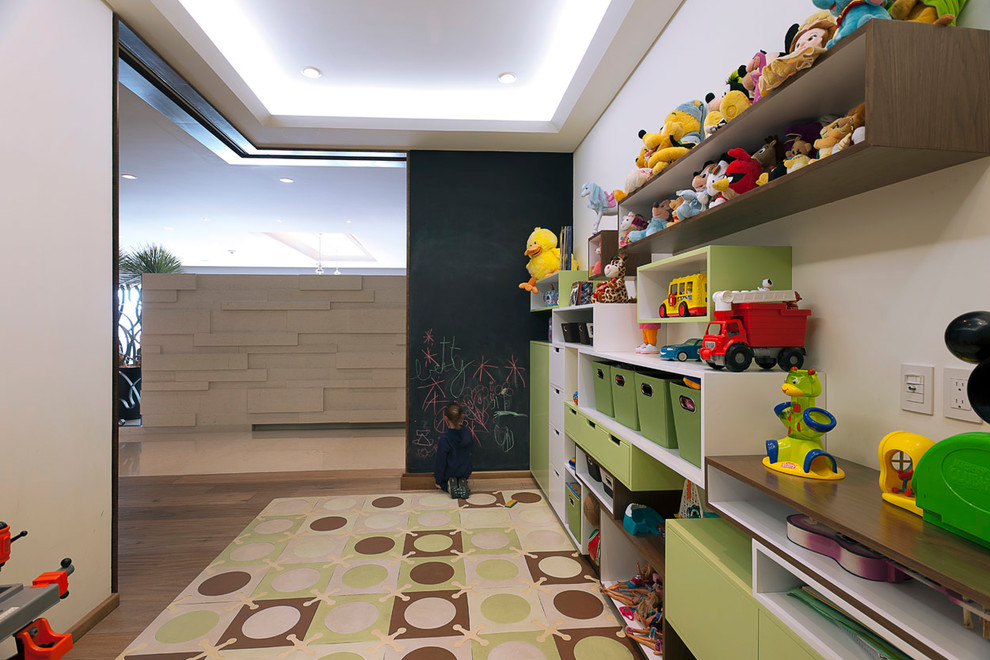 Example of a trendy gender-neutral medium tone wood floor kids' room design with white walls