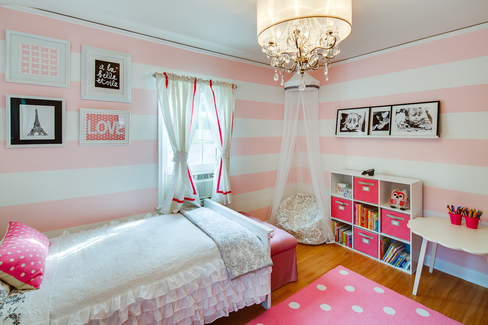 Design ideas for a contemporary children’s room for girls in Minneapolis with medium hardwood flooring and multi-coloured walls.