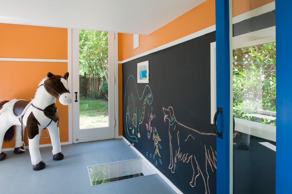 Example of a trendy gender-neutral painted wood floor playroom design in DC Metro with orange walls