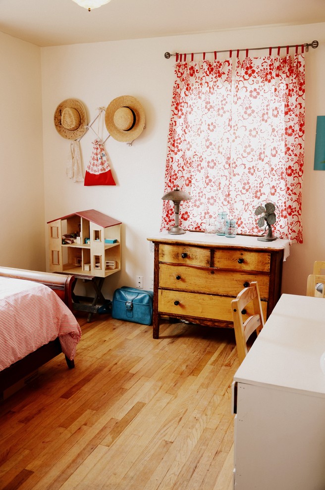 Kids' room - eclectic girl medium tone wood floor kids' room idea in Portland with beige walls