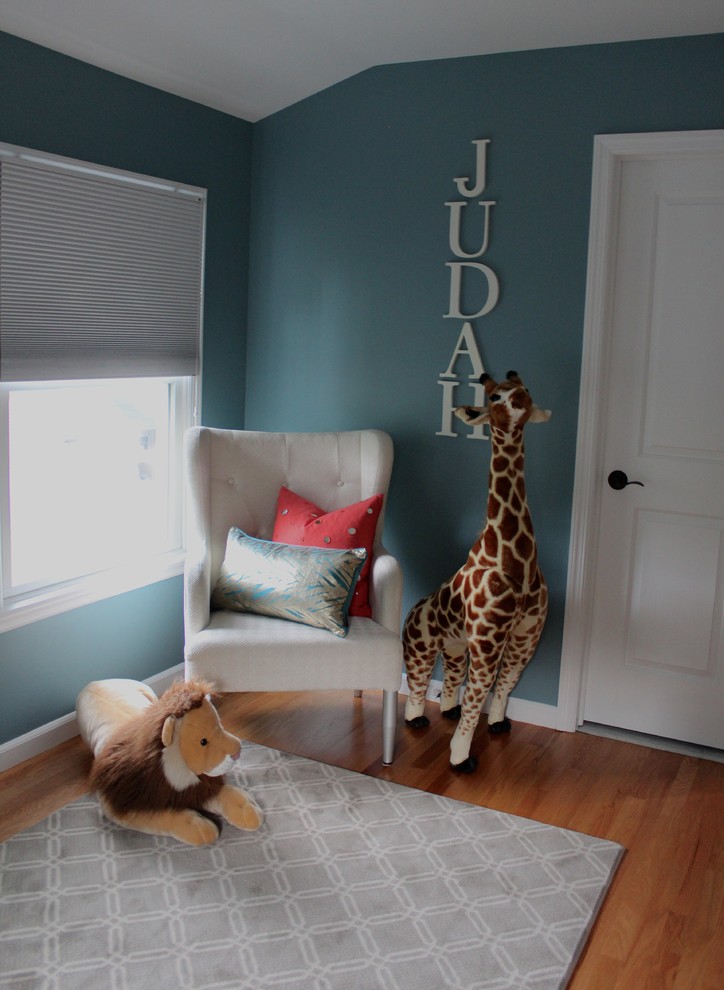 Inspiration for a contemporary kids' bedroom for boys in New York with blue walls and medium hardwood flooring.