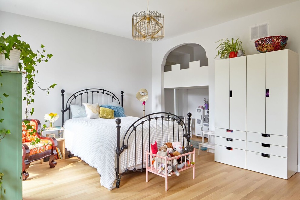 Foto di una cameretta per bambini da 4 a 10 anni scandinava di medie dimensioni con pareti bianche, parquet chiaro e pavimento marrone