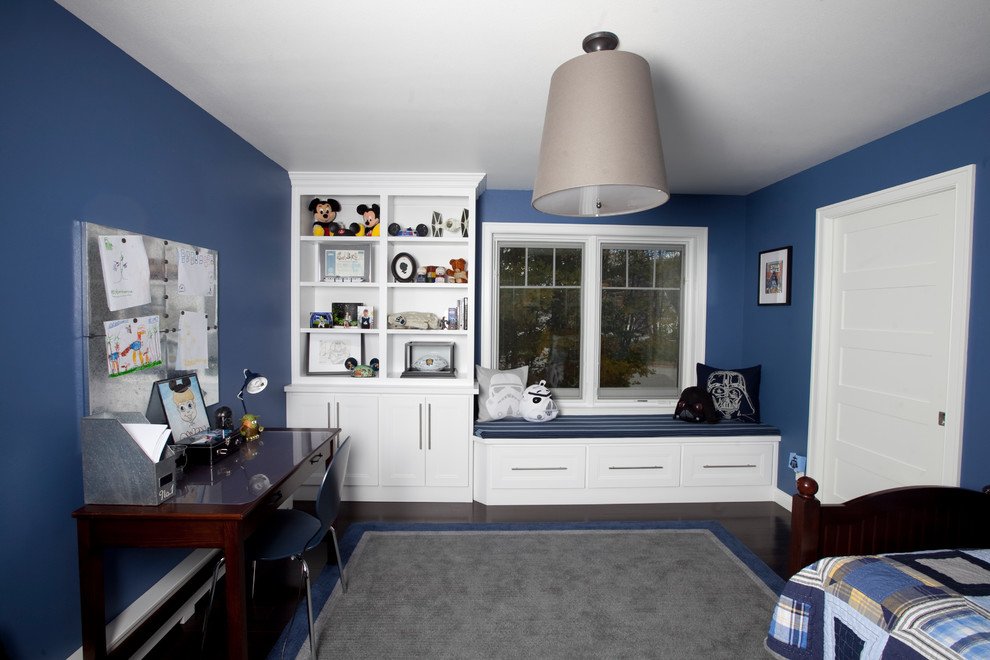 This is an example of a modern children’s room for boys in Other with blue walls and dark hardwood flooring.