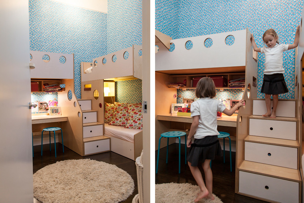 Small trendy girl dark wood floor kids' room photo in New York with blue walls