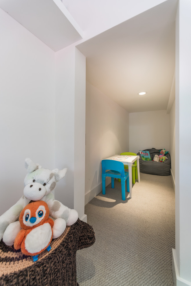 Mid-sized mid-century modern gender-neutral carpeted and brown floor kids' room photo in Los Angeles with white walls