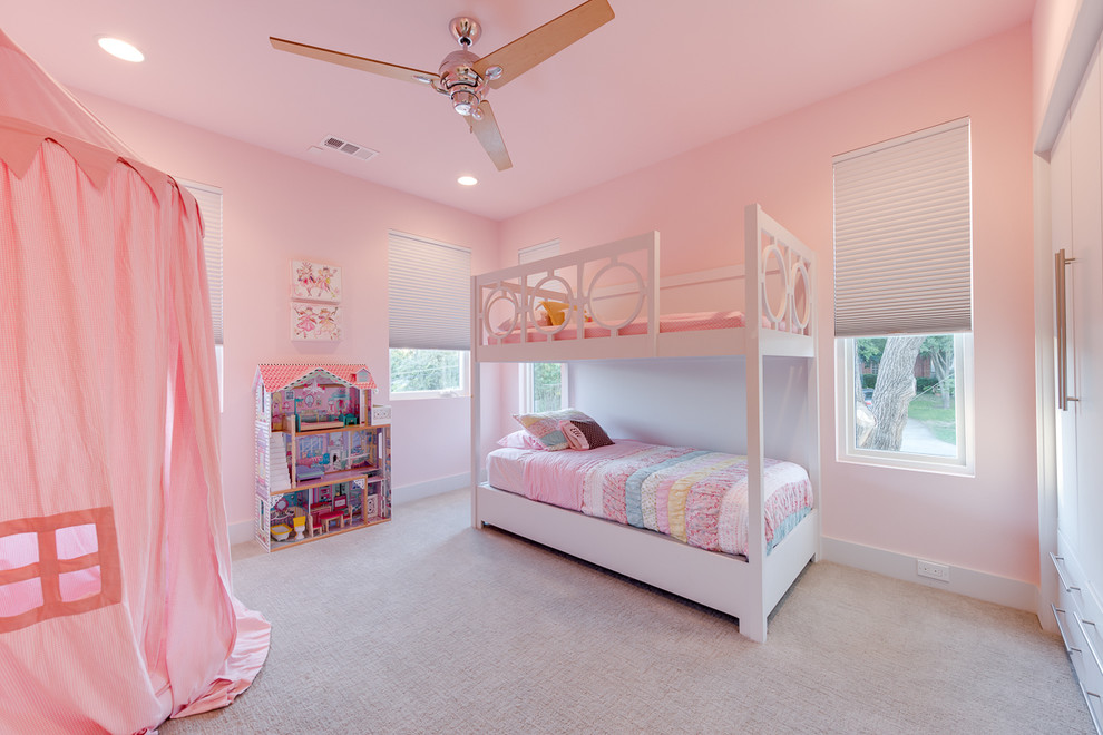 This is an example of a contemporary kids' bedroom in Dallas with pink walls.