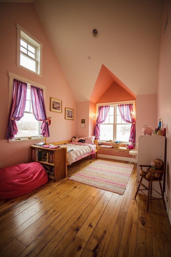 Example of a mid-sized classic girl medium tone wood floor kids' room design in Denver with pink walls