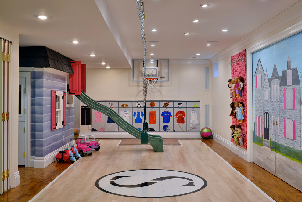 Traditional gender neutral playroom in New York with beige walls and medium hardwood flooring.