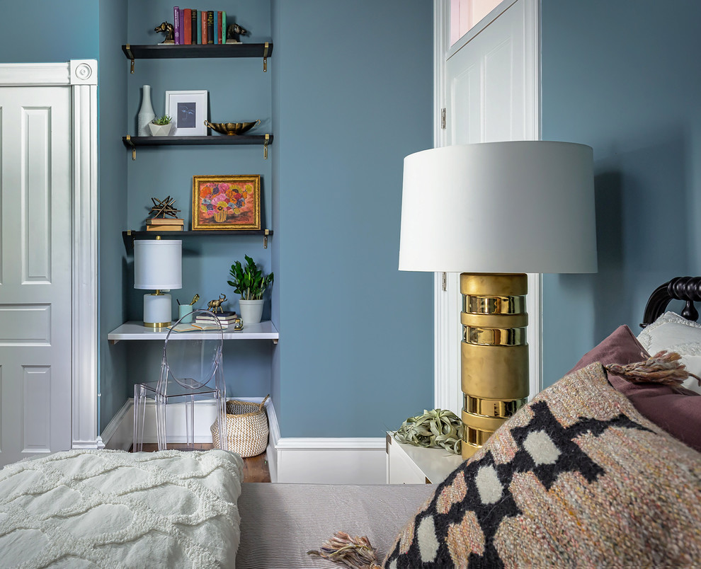Example of a mid-sized eclectic girl medium tone wood floor and brown floor kids' room design in DC Metro with blue walls