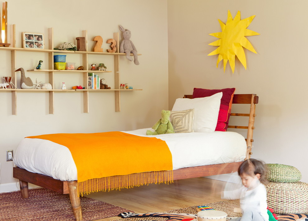 Foto på ett mellanstort 60 tals könsneutralt barnrum kombinerat med sovrum och för 4-10-åringar, med beige väggar och ljust trägolv