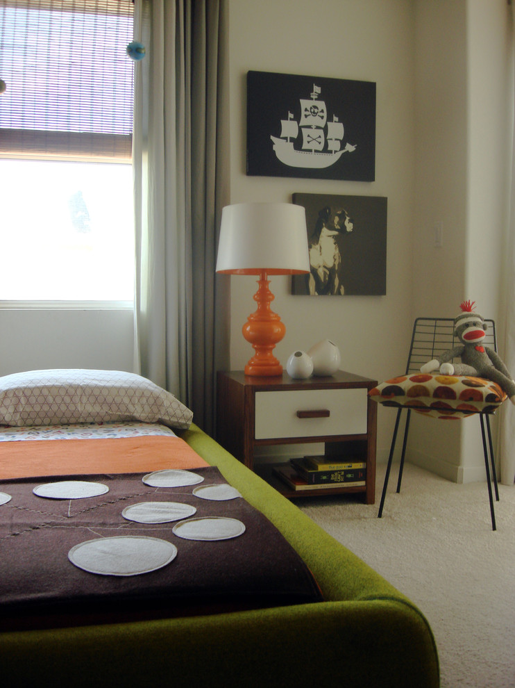 This is an example of an eclectic children’s room for boys in Orange County with beige walls and carpet.
