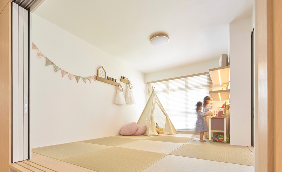 Contemporary playroom for girls in Singapore with white walls and beige floors.