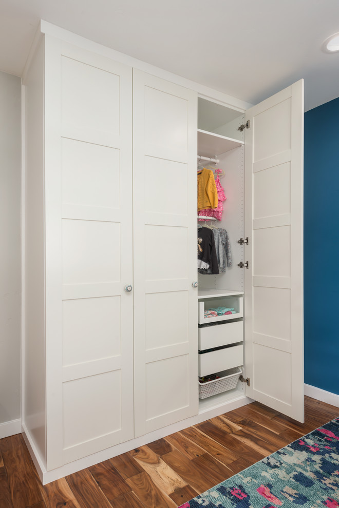 Inspiration for a mid-sized transitional girl medium tone wood floor kids' room remodel in San Francisco with blue walls