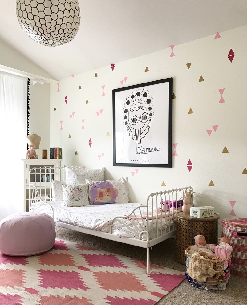 Scandi children’s room for girls in Denver with multi-coloured walls and carpet.