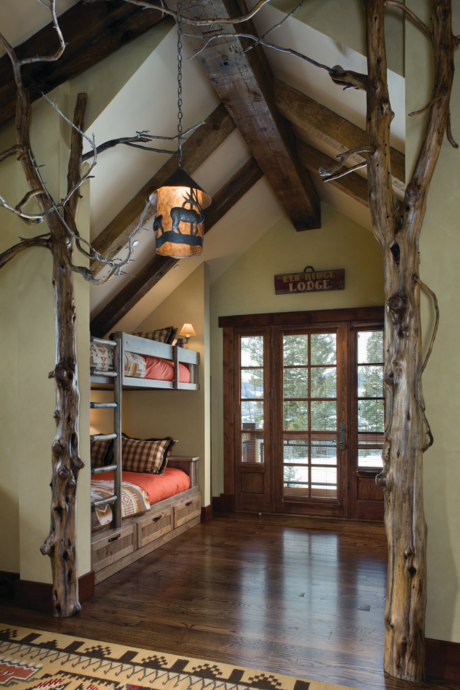 Design ideas for a rustic gender neutral children’s room in Other with green walls and dark hardwood flooring.