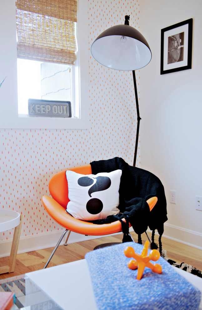 Photo of a medium sized classic gender neutral kids' bedroom in Kansas City with orange walls and light hardwood flooring.