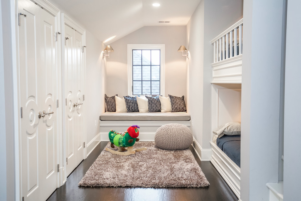 Example of a classic gender-neutral dark wood floor kids' room design in DC Metro with white walls