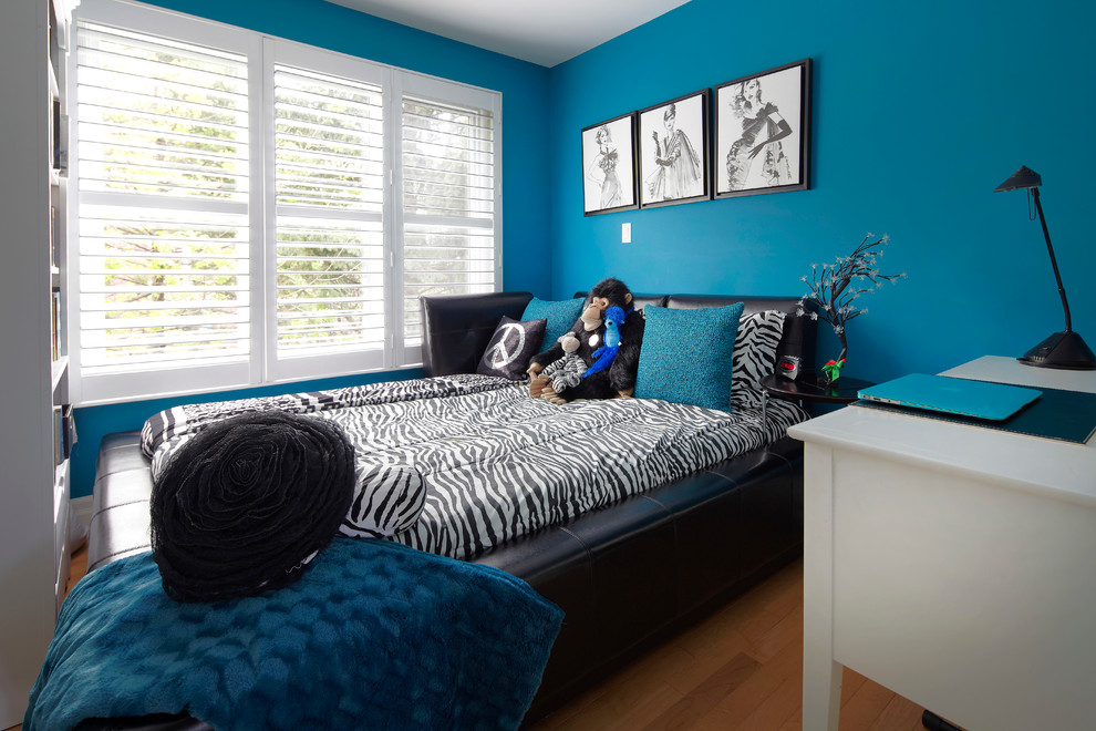 Medium sized classic teen’s room for girls in Toronto with blue walls and light hardwood flooring.