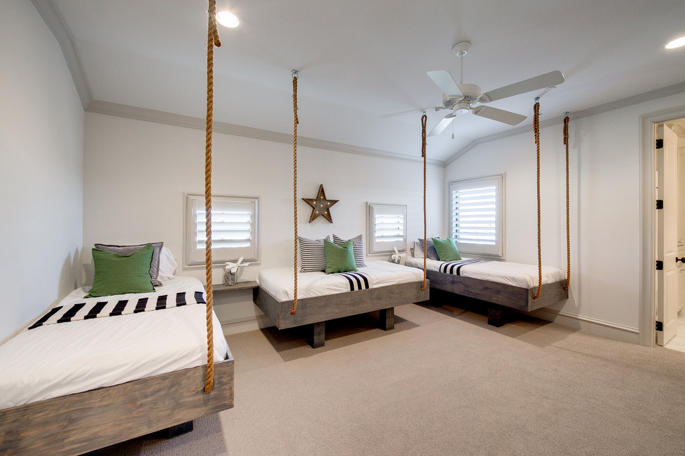 Inspiration for a large coastal children’s room for boys in Dallas with white walls and carpet.