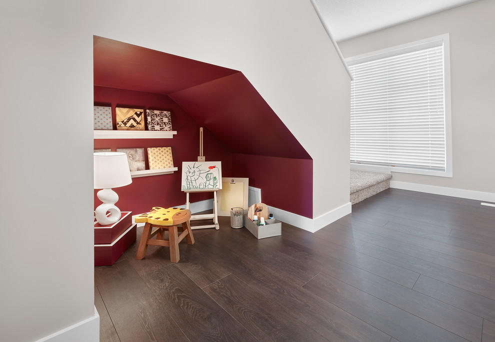 This is an example of a traditional gender neutral toddler’s room in Edmonton with red walls and dark hardwood flooring.