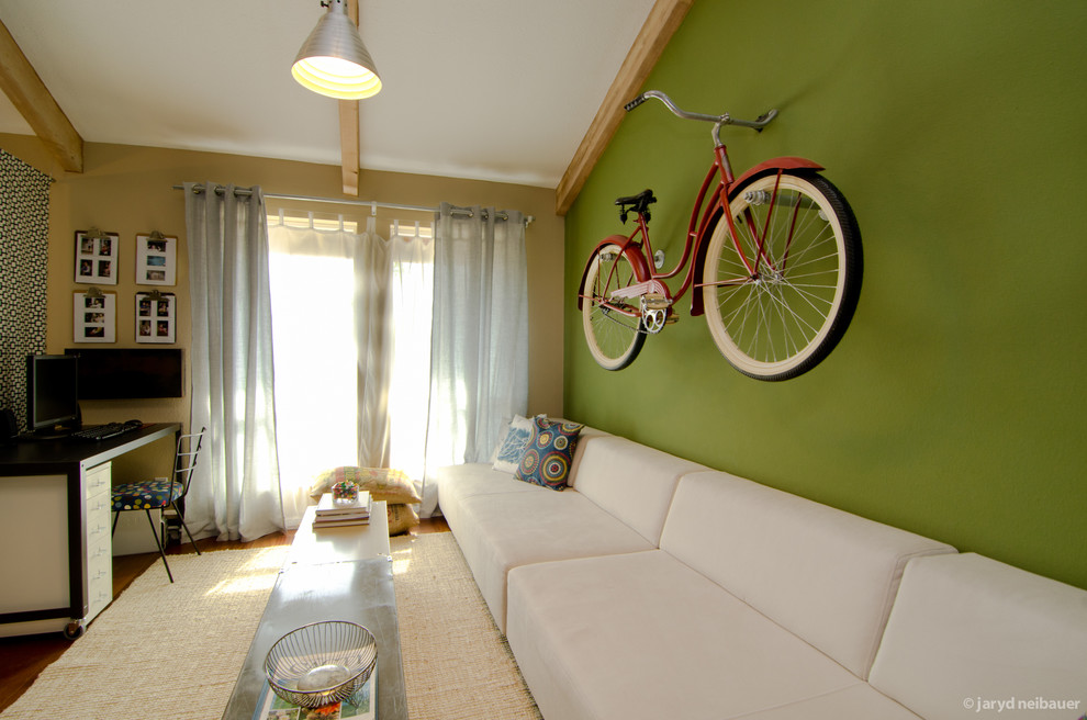 This is an example of a medium sized bohemian gender neutral kids' bedroom in Phoenix with green walls and medium hardwood flooring.