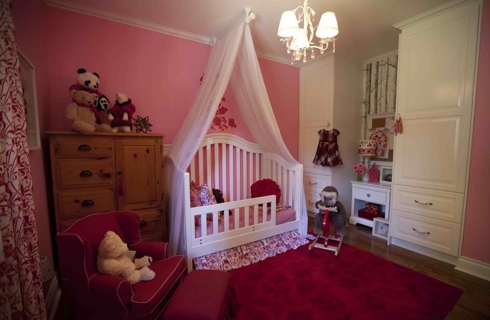 Small elegant girl medium tone wood floor kids' room photo in Vancouver with pink walls
