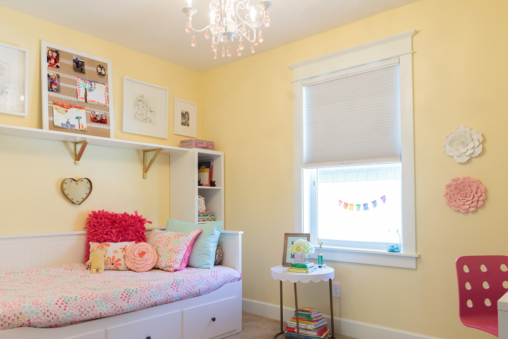 Example of a small transitional girl carpeted kids' room design in Portland with yellow walls