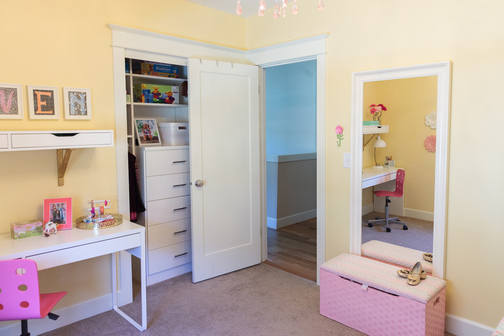 Inspiration for a small traditional children’s room for girls in Portland with yellow walls and carpet.