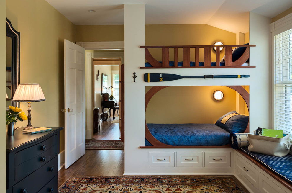 Design ideas for a beach style children’s room for boys in Portland Maine with yellow walls and dark hardwood flooring.