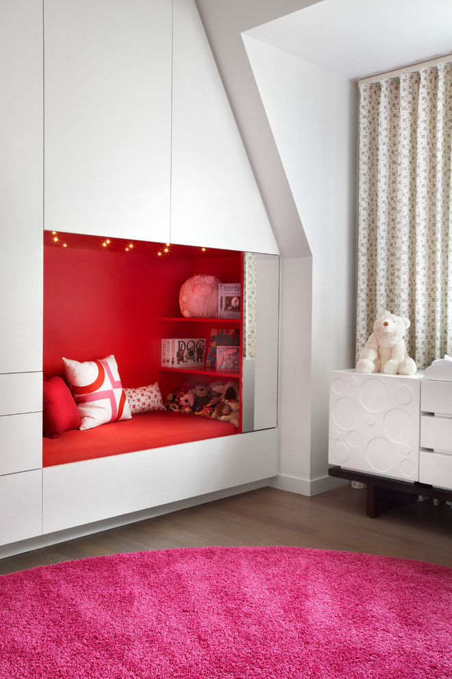 Medium sized contemporary kids' bedroom for girls in Toronto with white walls and dark hardwood flooring.