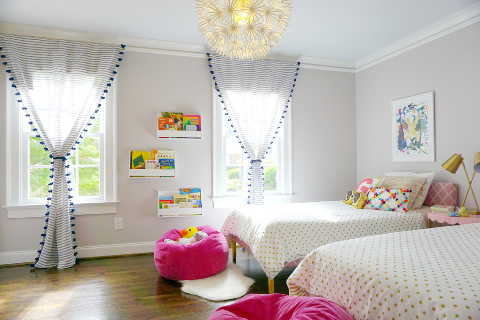 Medium sized contemporary toddler’s room for girls in Atlanta with grey walls, dark hardwood flooring and brown floors.