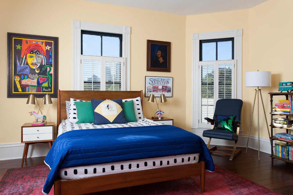 This is an example of a bohemian teen’s room in Austin with yellow walls and dark hardwood flooring.