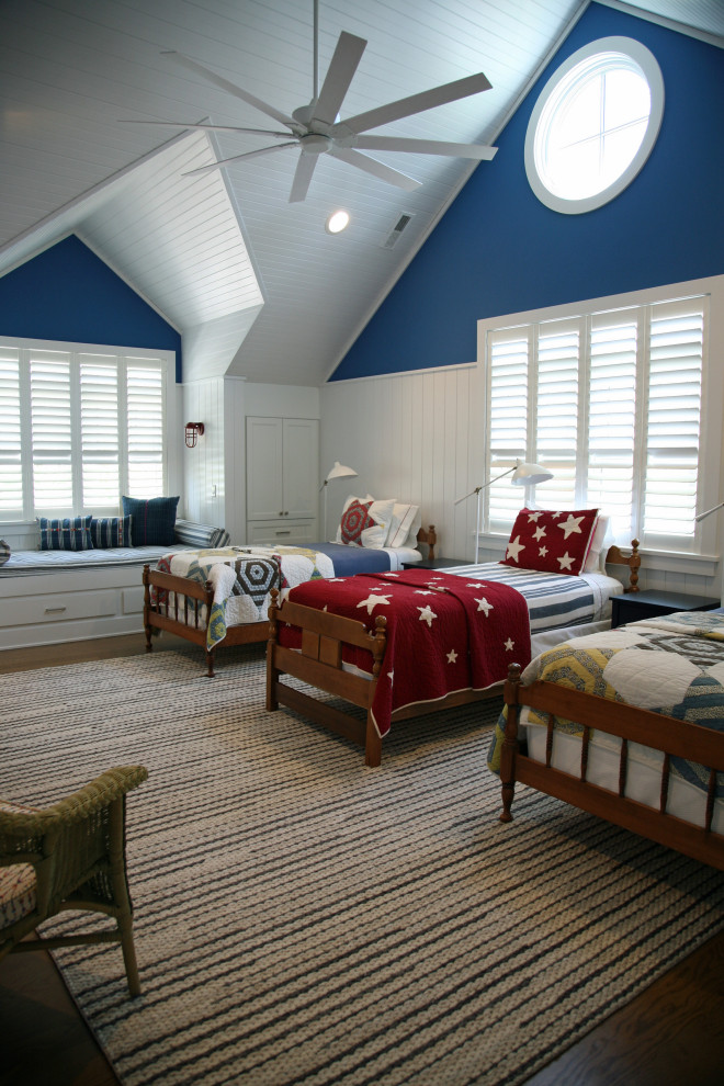 Large nautical gender neutral teen’s room in Milwaukee with blue walls, medium hardwood flooring, brown floors, a vaulted ceiling and wood walls.