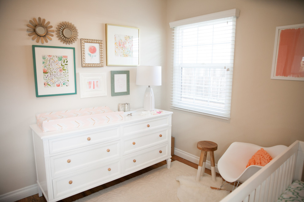 Inspiration for a medium sized classic toddler’s room for girls in Orange County with beige walls and medium hardwood flooring.