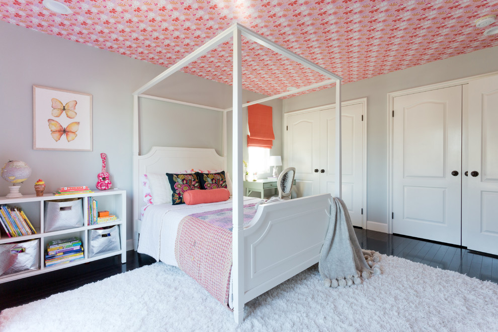 This is an example of a large traditional kids' bedroom for girls in Los Angeles with grey walls and dark hardwood flooring.