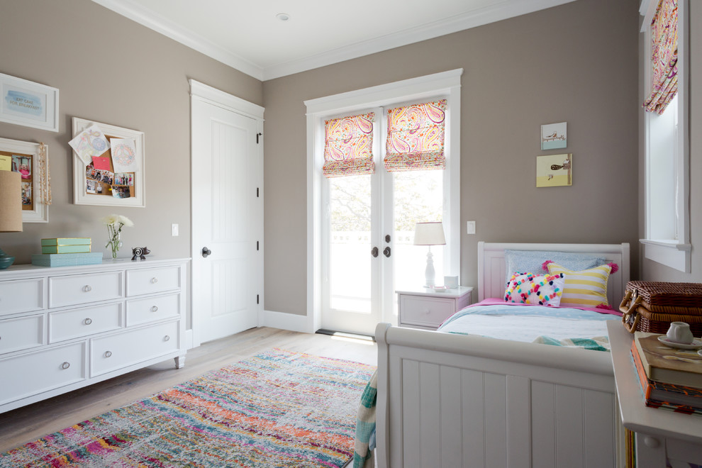 Mid-sized transitional girl medium tone wood floor kids' room photo in Los Angeles with brown walls