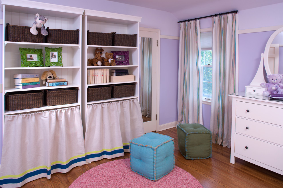 Inspiration for a contemporary kids' bedroom for girls in Minneapolis with purple walls and medium hardwood flooring.