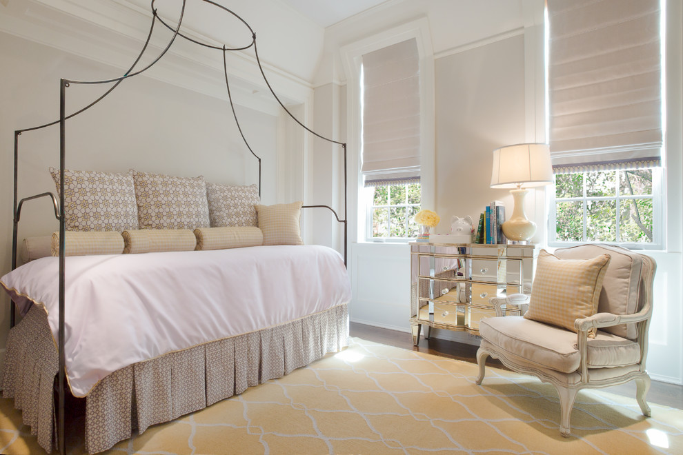 This is an example of a classic children’s room for girls in Chicago with white walls and medium hardwood flooring.