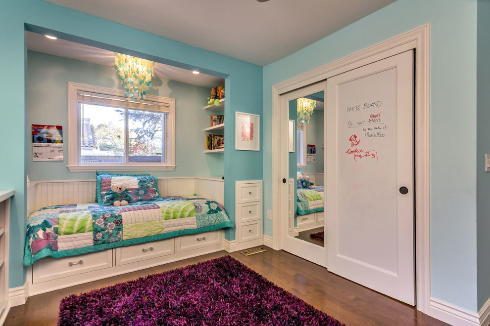 Inspiration for a small classic children’s room for girls in San Francisco with blue walls and medium hardwood flooring.