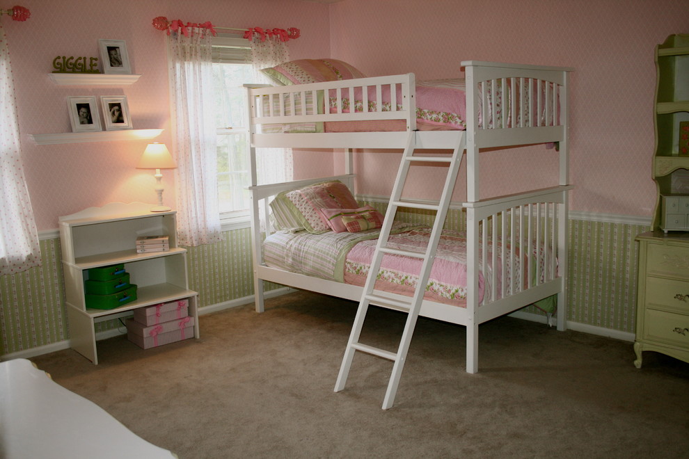 Example of a classic girl carpeted kids' room design in Other with pink walls