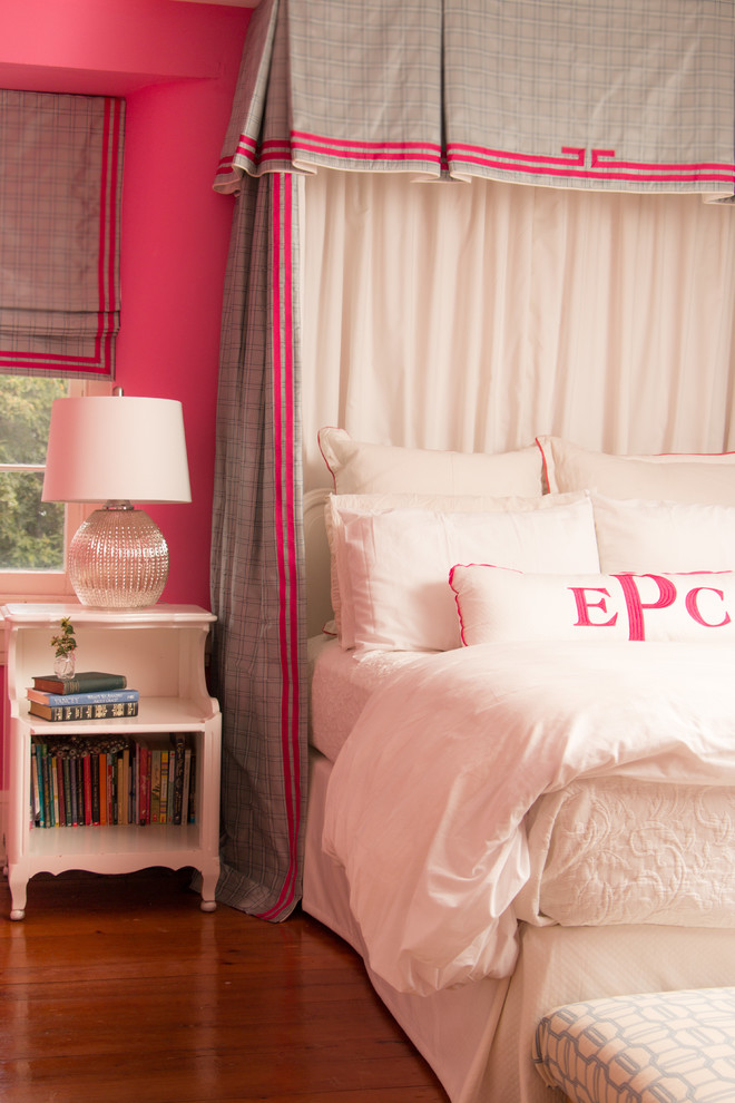 Example of a mid-sized transitional girl medium tone wood floor kids' room design in Philadelphia with pink walls