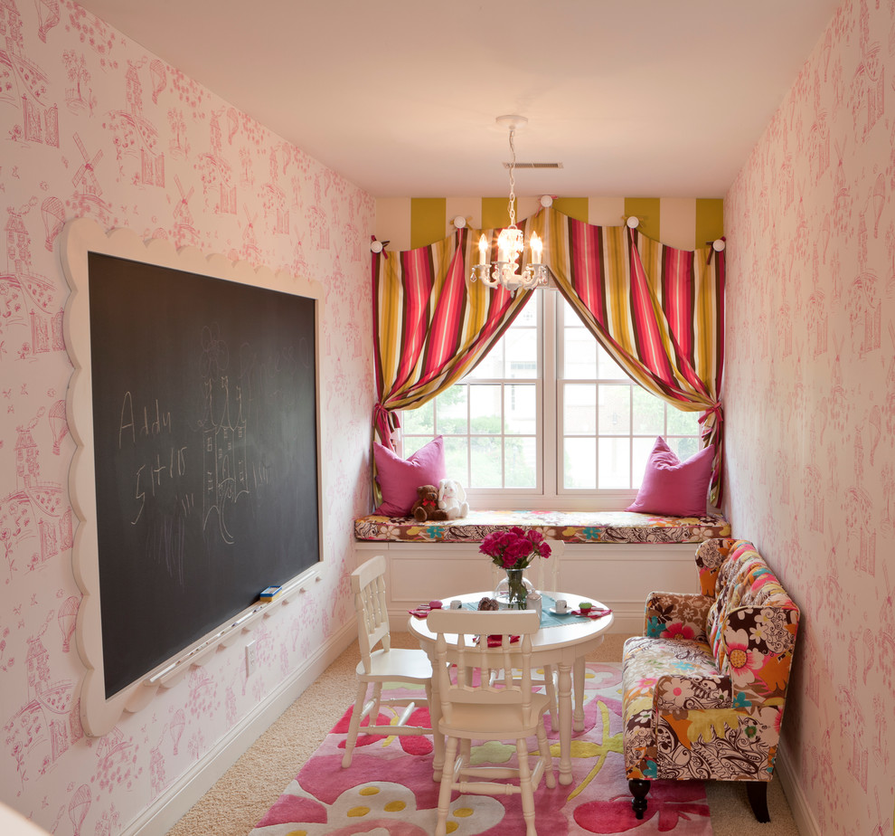 Photo of a small classic toddler’s room for girls in Cincinnati with pink walls and carpet.